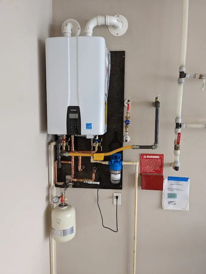 Professional plumber installing copper piping in a Hellam home